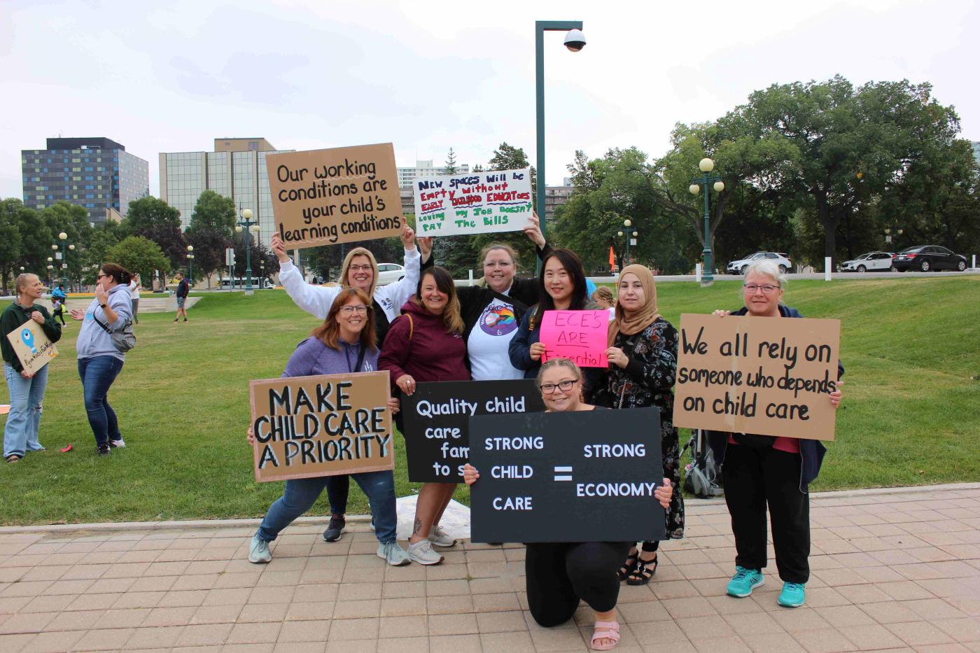 staff standing with signs